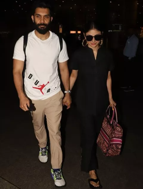 Mouni Roy Papped At The Airport With Hubby, Suraj Nambiar, Carries A ...