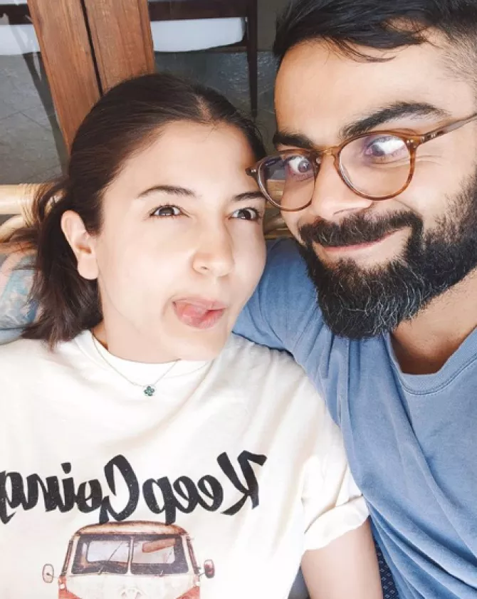 Peck it out! Virat Kohli and Anushka Sharma lock it with love