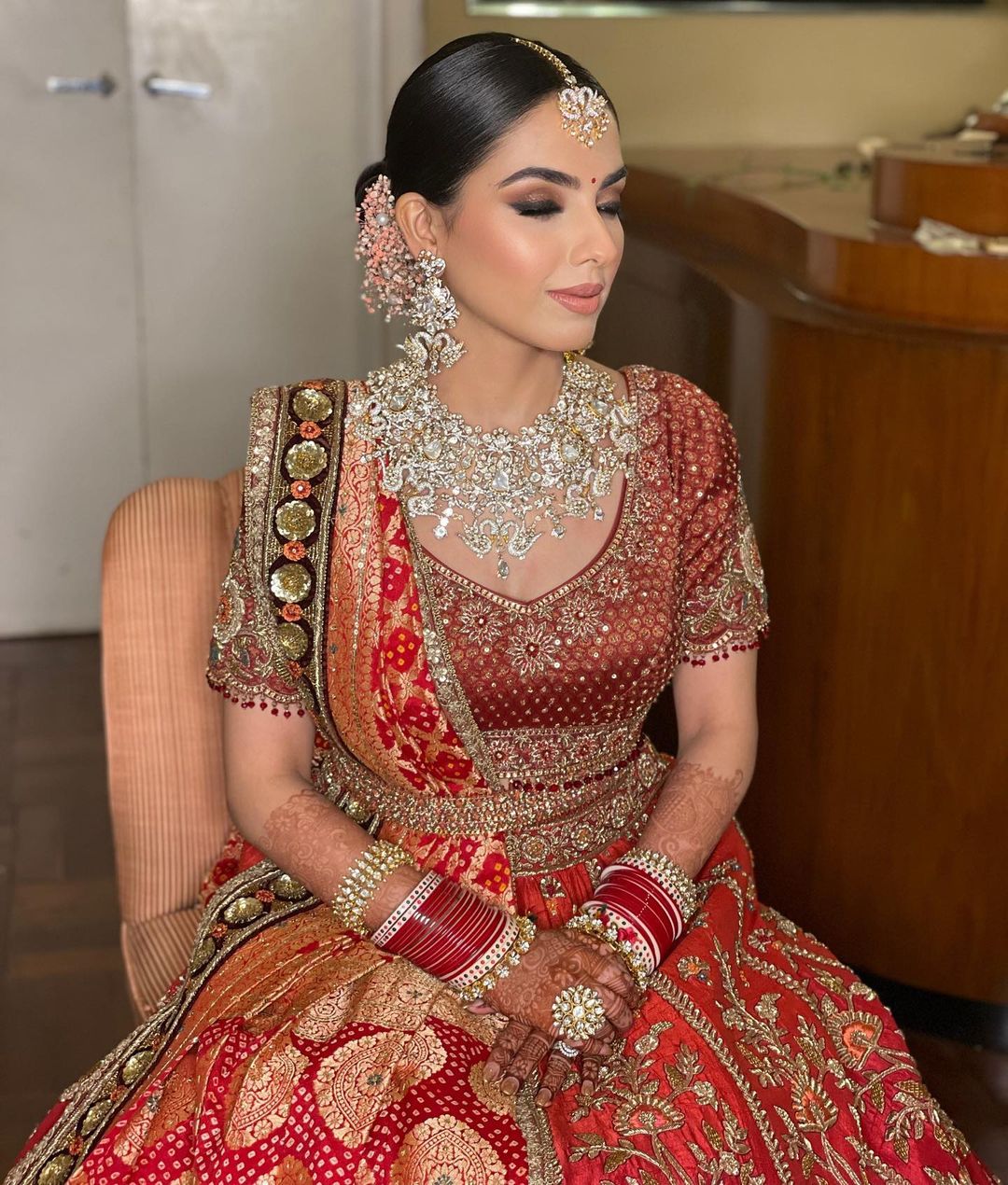 Shruti - A classic red bridal lehenga, exquisite jewellery & a traditional  look, brings back the surreal charm. Bride - Isha Makeup - @shrutiasharma  Hair - @rohithairofficial Outfit - @sabyasachiofficial For Booking ,
