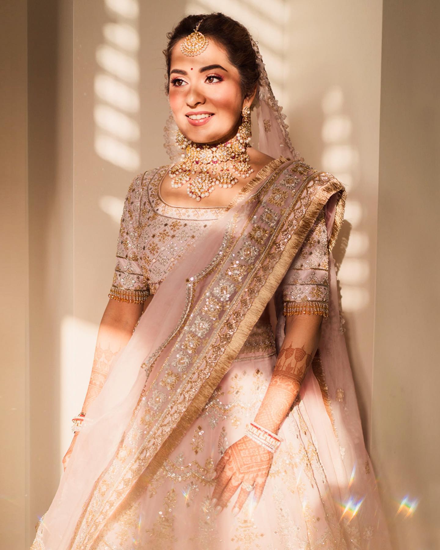 Photo of Bride posing in light pink lehenga and contrasting green jewellery  | Pakistani bridal, Indian wedding dress, Indian bride