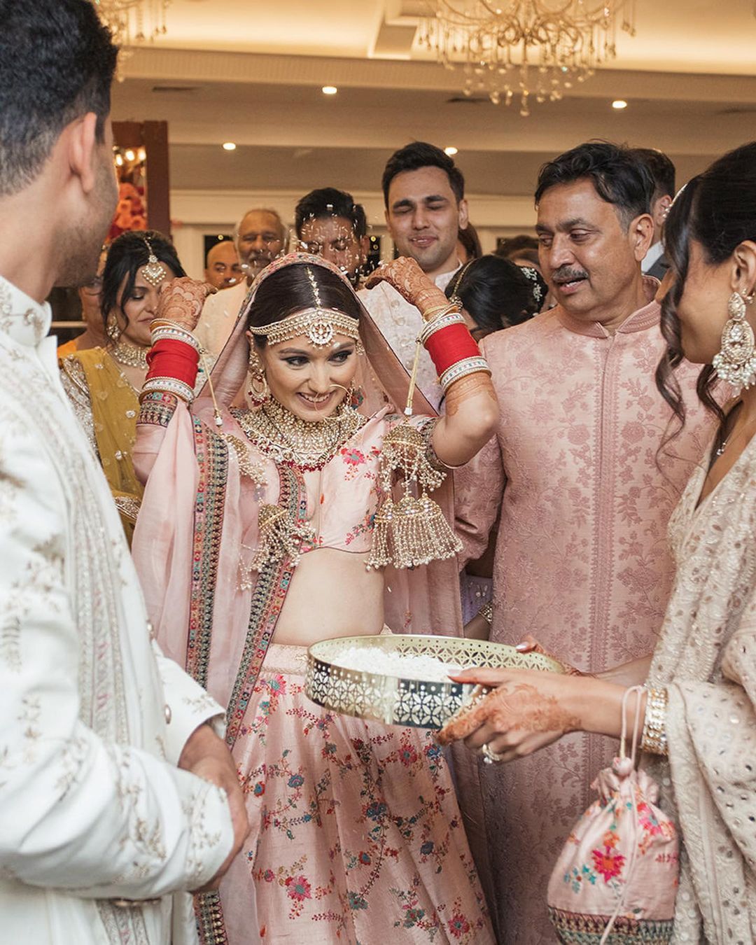 Rashi Sehgal Studio - Bride @nikhitaaaa looked resplendent in neutral tone  bridal lehenga with minimal diamond jewellery and pink chuda. Played with  pinks and browns, chose to ditch falsies with the perfect